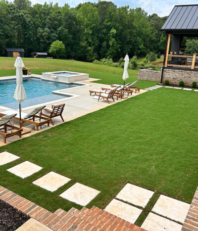 Backyard pool, patio, and green yard