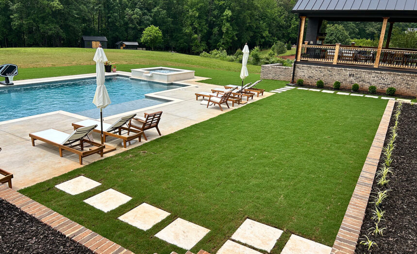 Backyard pool, patio, and green yard