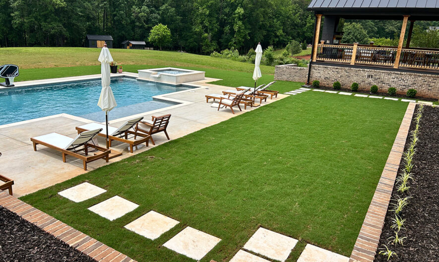 Backyard pool, patio, and green yard