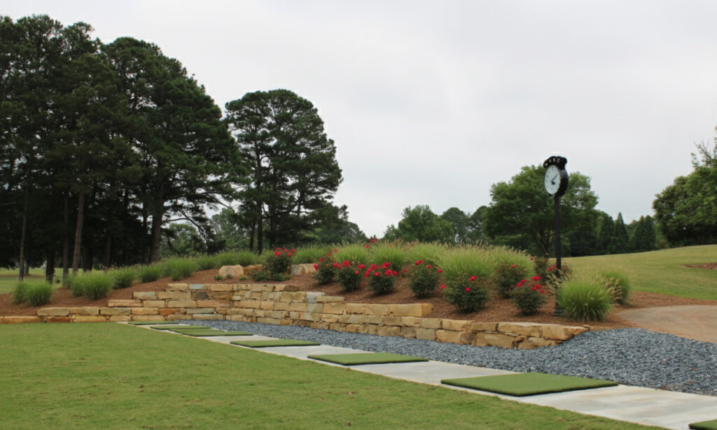 Green lawn with stone retaining wall