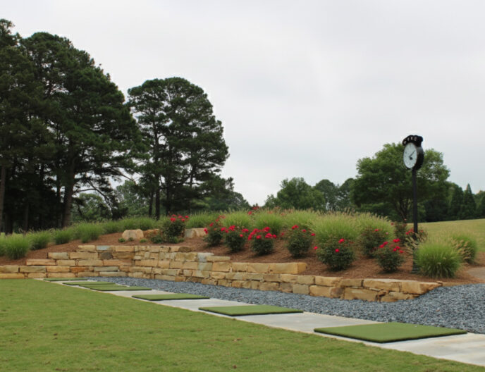 driving range wall scaled Green lawn with stone retaining wall