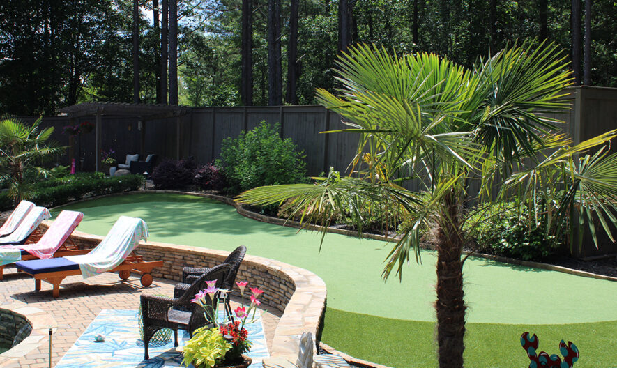 green scaled Backyard putting green with lounge chairs and tree